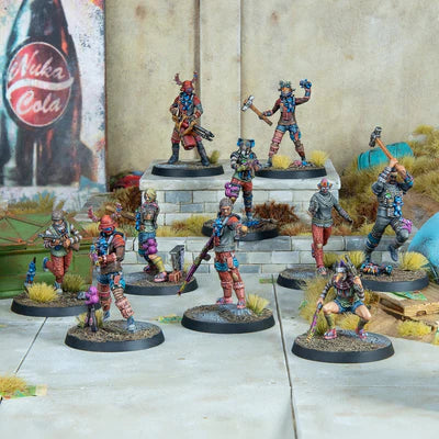 Collection of miniature figurines on a reflective surface with a colorful mural in the background.